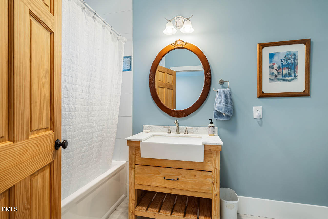3833 Blakely Way Efland, NC 27243 - Photo 42 of 69 a bathroom with a sink a mirror and a bathtub