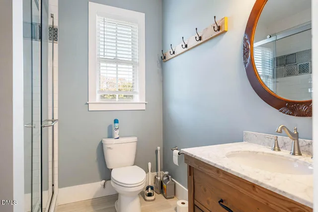 a view of a swimming pool with a bench and trees in the background