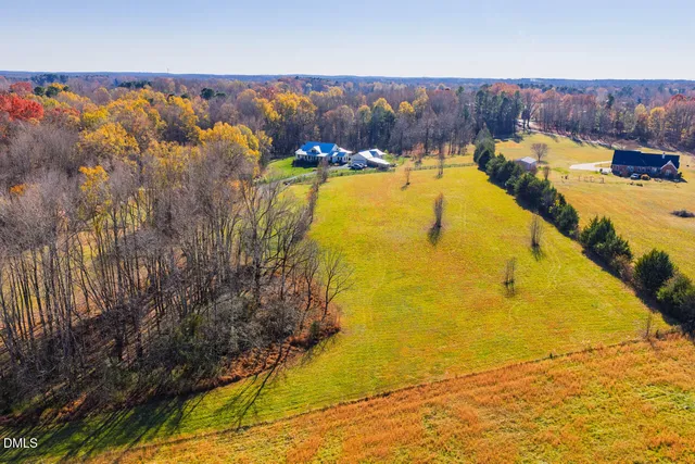 a front view of a house with a yard and potted plants