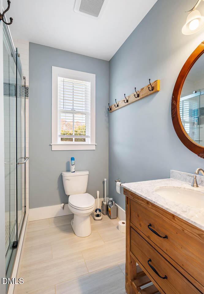 3833 Blakely Way Efland, NC 27243 - Photo 51 of 69 a bathroom with a sink mirror vanity and toilet