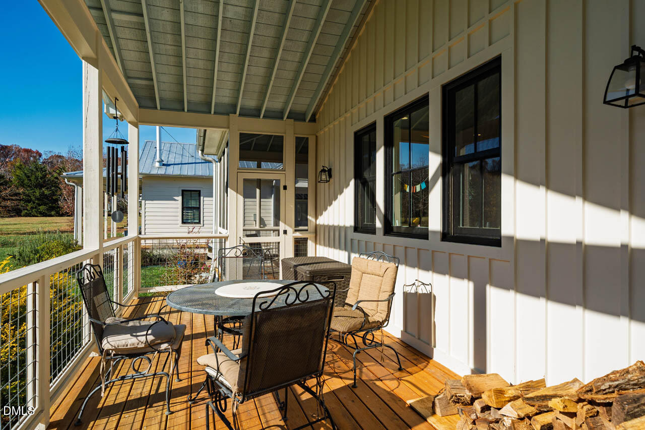 3833 Blakely Way Efland, NC 27243 - Photo 56 of 69 a view of a patio with table and chairs with wooden floor and fence