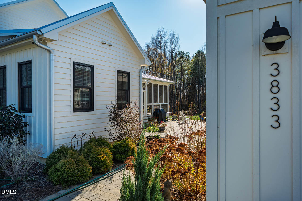 3833 Blakely Way Efland, NC 27243 - Photo 57 of 69 a view of a house with a yard and garden