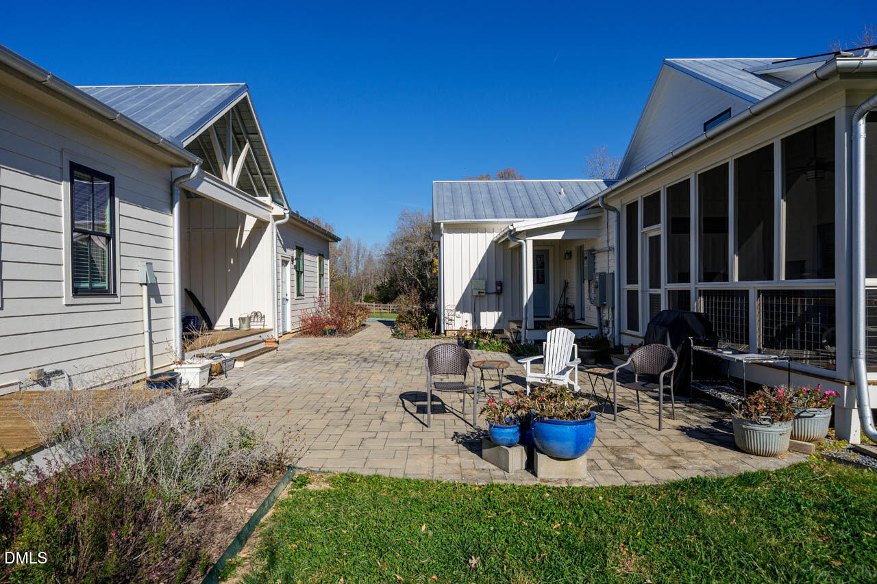 3833 Blakely Way Efland, NC 27243 - Photo 58 of 69 a view of a patio with chairs and potted plants