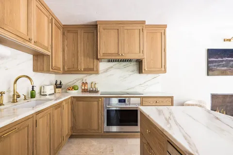 a kitchen with stainless steel appliances granite countertop a sink and cabinets