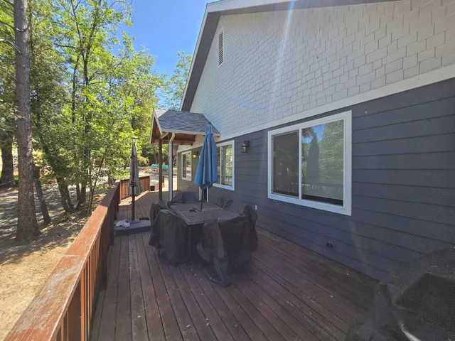 a kitchen with kitchen island granite countertop a stove and a sink