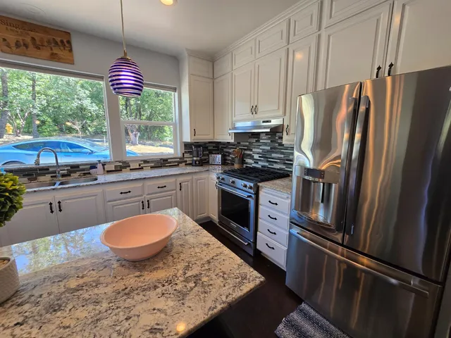 a bedroom with a bed couch and a window