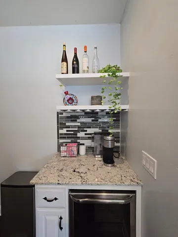 a bathroom with a granite countertop toilet a sink and a mirror