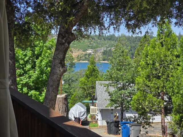 a living room with furniture kitchen view and a large window