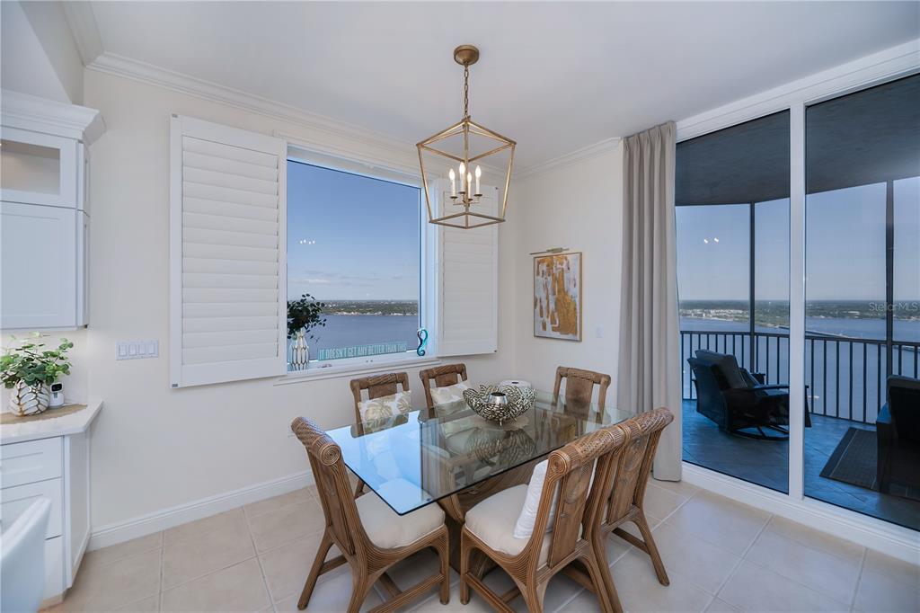 2104 West First Street, Unit 3103 Fort Myers, FL 33901 - Photo 17 of 74 a dining room with furniture potted plants and wooden floor