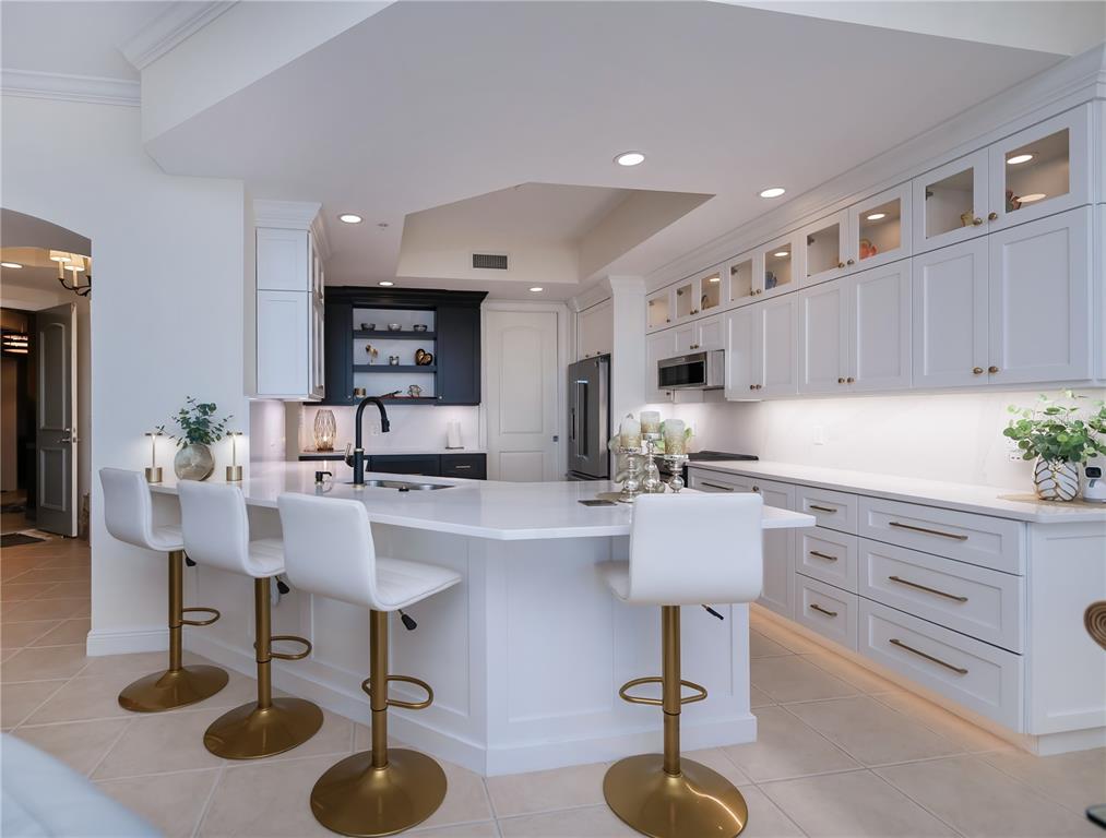 2104 West First Street, Unit 3103 Fort Myers, FL 33901 - Photo 21 of 74 a kitchen with stainless steel appliances granite countertop a sink and cabinets