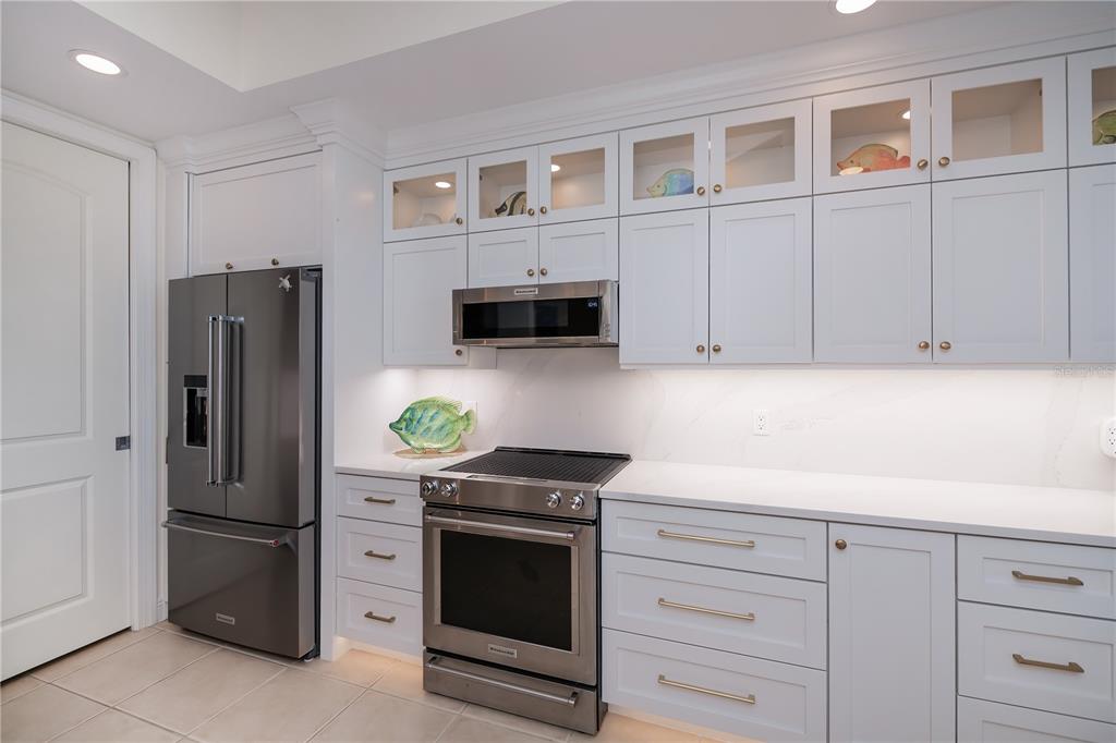 2104 West First Street, Unit 3103 Fort Myers, FL 33901 - Photo 23 of 74 a kitchen with stainless steel appliances white cabinets and a refrigerator