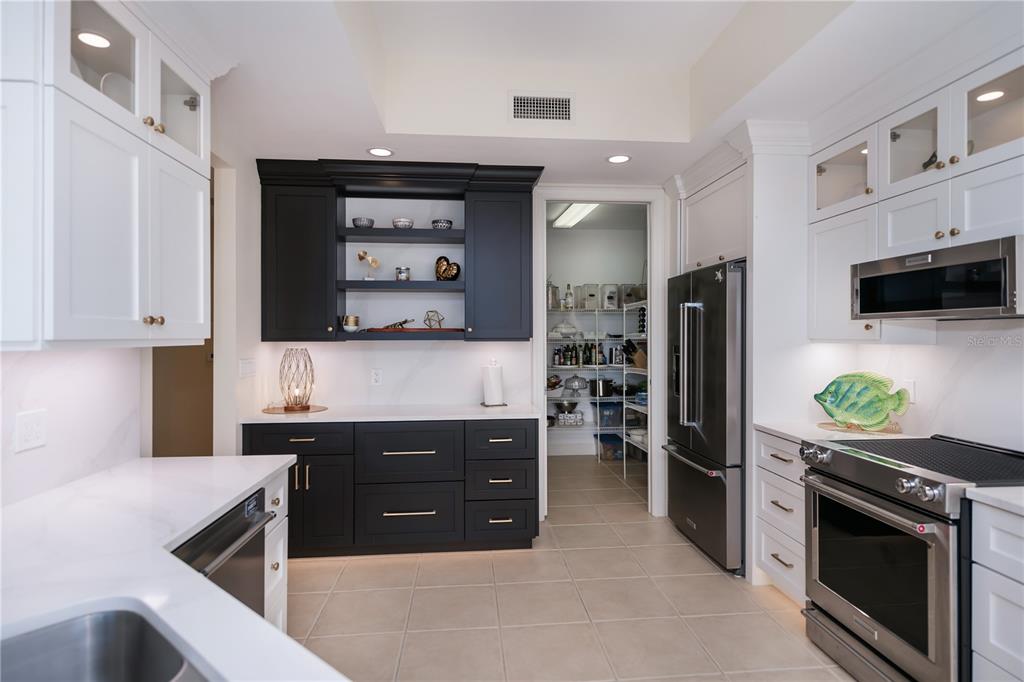 2104 West First Street, Unit 3103 Fort Myers, FL 33901 - Photo 26 of 74 a kitchen with stainless steel appliances a sink stove and refrigerator