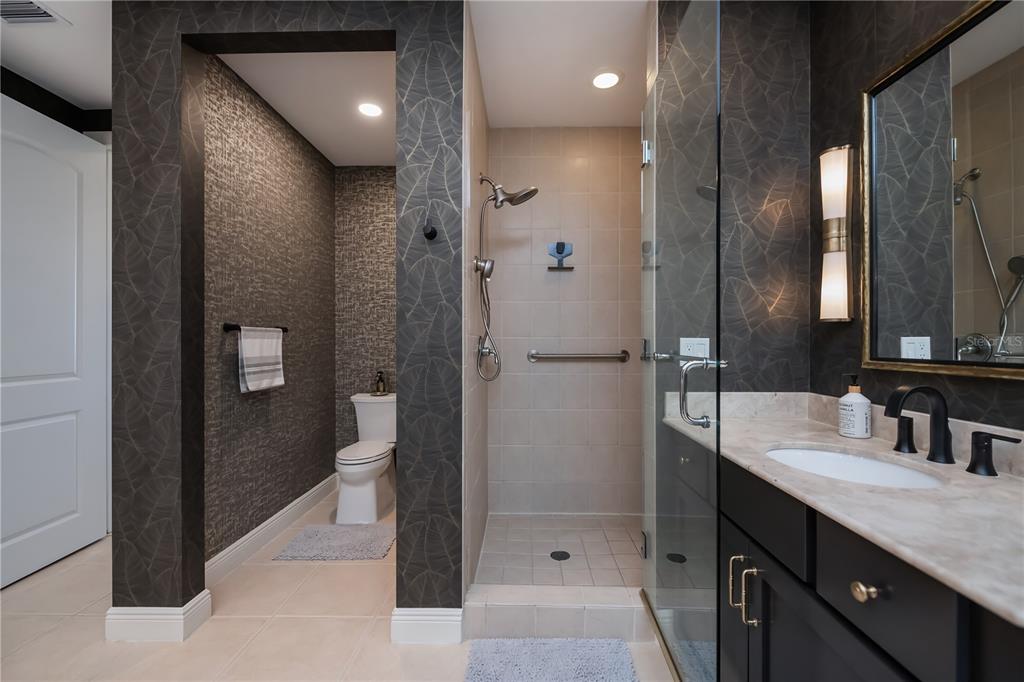 2104 West First Street, Unit 3103 Fort Myers, FL 33901 - Photo 36 of 74 a bathroom with a granite countertop sink mirror and shower