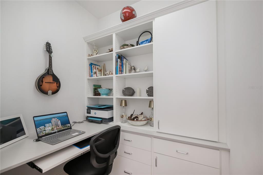2104 West First Street, Unit 3103 Fort Myers, FL 33901 - Photo 38 of 74 a kitchen with a shelf and a book shelf