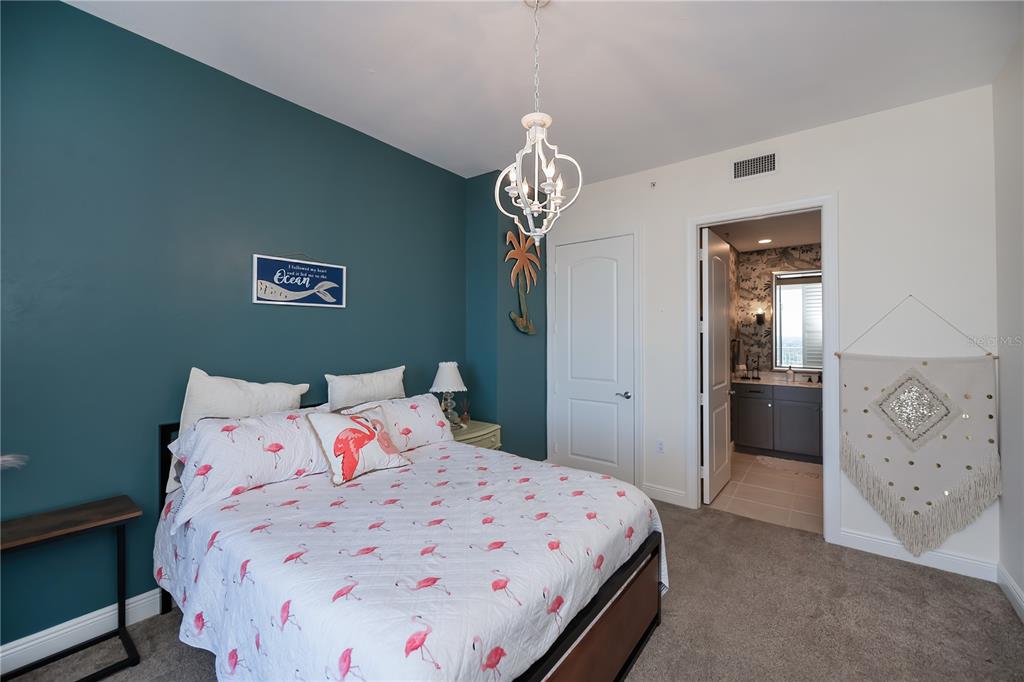 2104 West First Street, Unit 3103 Fort Myers, FL 33901 - Photo 41 of 74 a bedroom with a bed and a chandelier