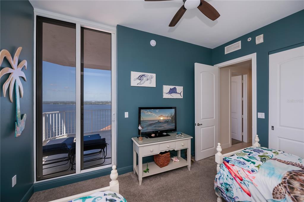 2104 West First Street, Unit 3103 Fort Myers, FL 33901 - Photo 47 of 74 a bedroom with a bed and a flat screen tv