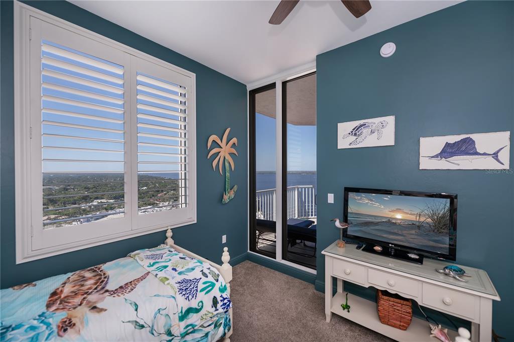 2104 West First Street, Unit 3103 Fort Myers, FL 33901 - Photo 49 of 74 a bedroom with furniture and a flat screen tv