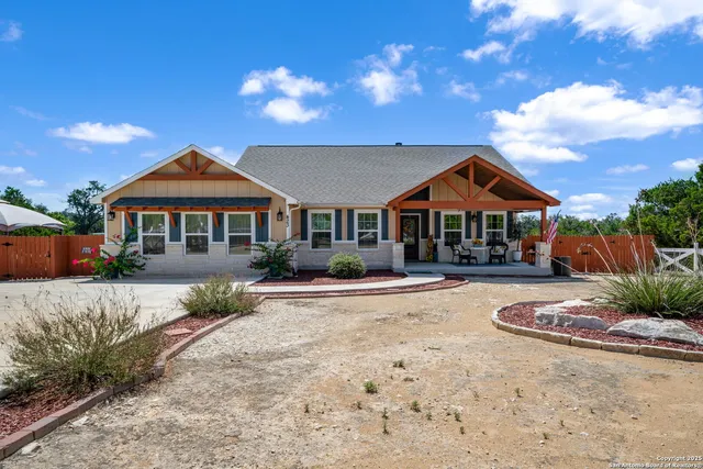 a front view of a house with yard patio and outdoor seating