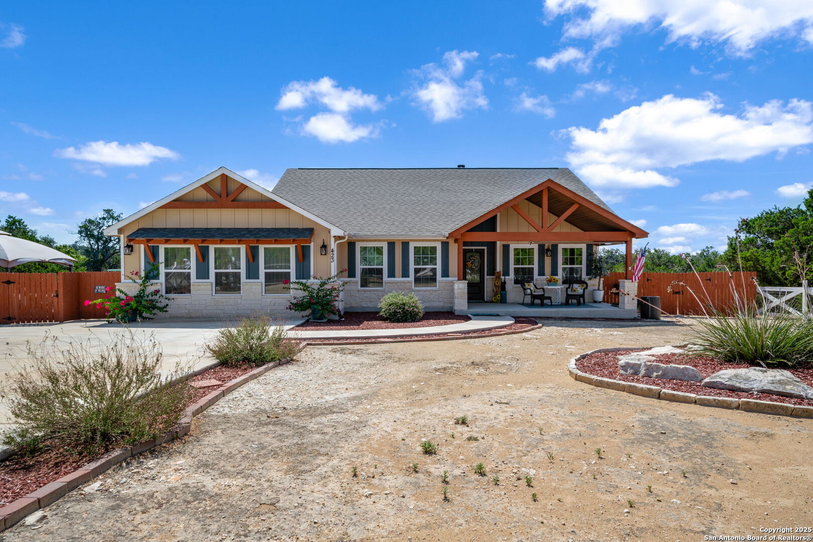 a front view of a house with yard patio and outdoor seating