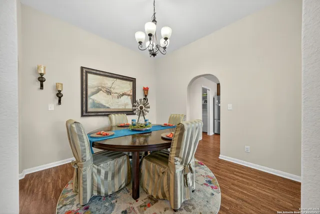 a view of a dining room with furniture and chandelier