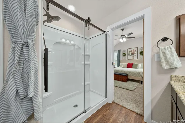 a spacious bedroom with a bed and a chandelier