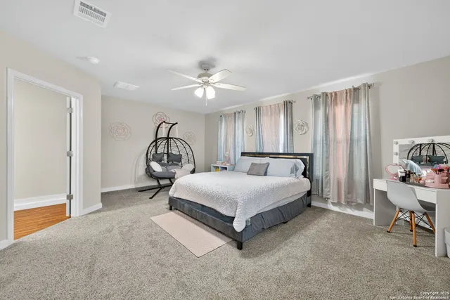 a bedroom with a large bed couch and a window