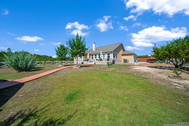 a swimming pool with outdoor seating and yard
