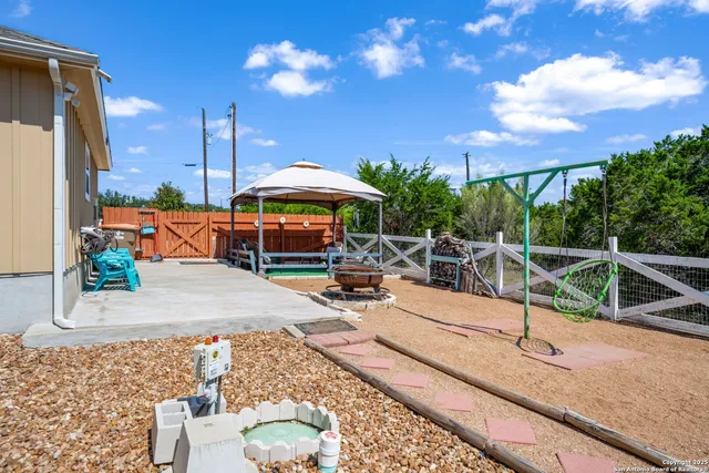 a view of a house with a yard and tree s
