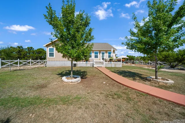 a view of a house with swimming pool and sitting area