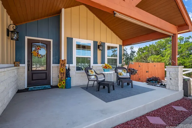 a view of a patio with table and chairs and potted plants