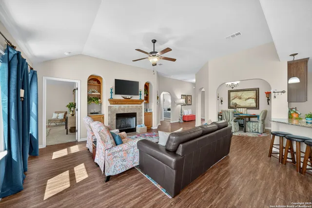 a living room with fireplace furniture and a wooden floor