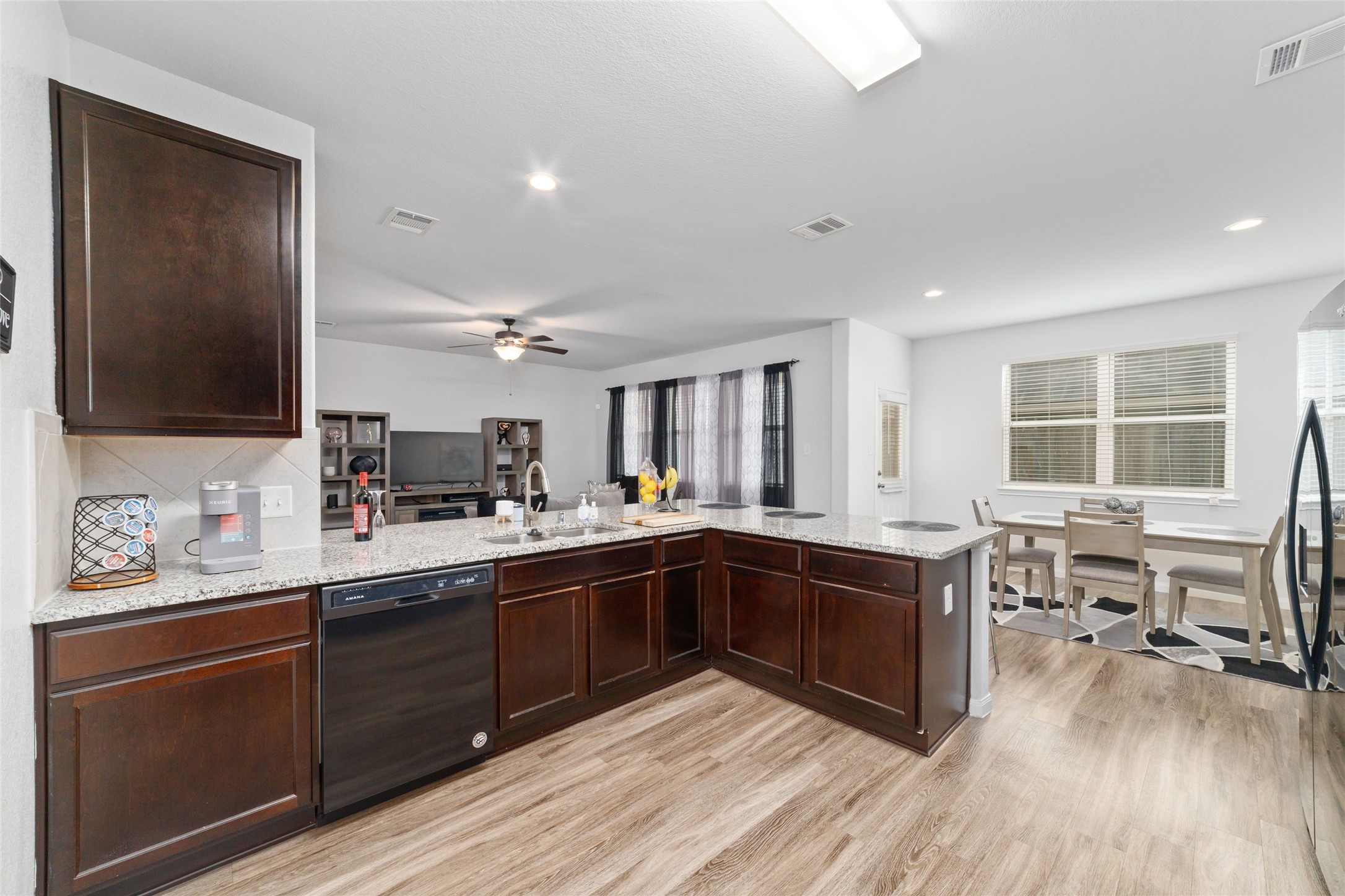 18619 Cooper Ravine Way Katy, TX 77449 - Photo 10 of 23 a kitchen with stainless steel appliances granite countertop cabinets wooden floor and a sink