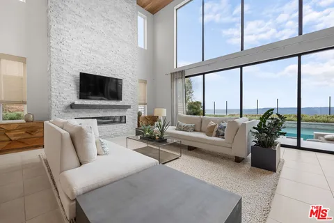 a kitchen with kitchen island granite countertop a sink counter top space appliances and cabinets