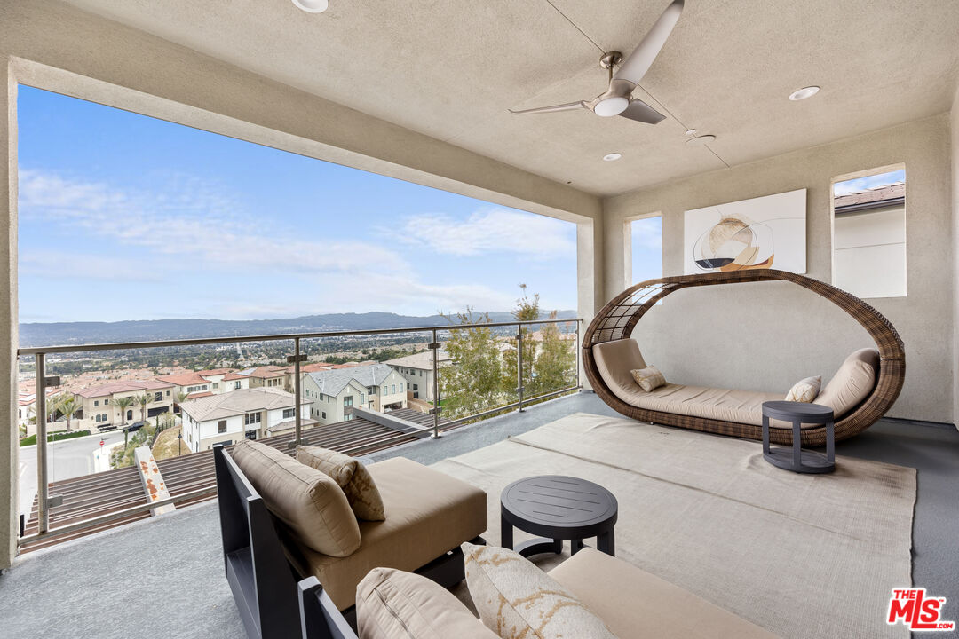 20378 Marlow Lane Porter Ranch, CA 91326 - Photo 24 of 52 a living room with furniture a rug and white walls