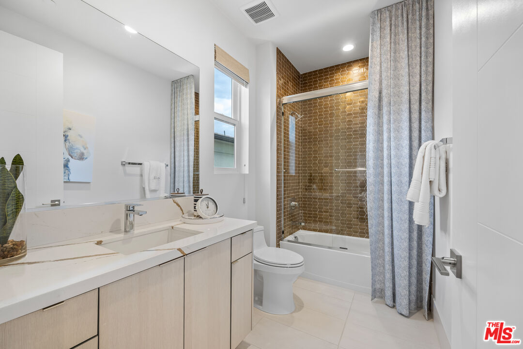 20378 Marlow Lane Porter Ranch, CA 91326 - Photo 33 of 52 a bathroom with a double vanity sink toilet and shower