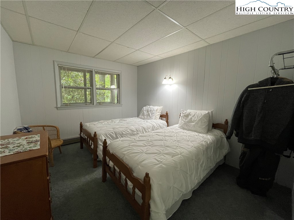 911 Pine Ridge Road Beech Mountain, NC 28604 - Photo 17 of 22 a bedroom with two beds and a window