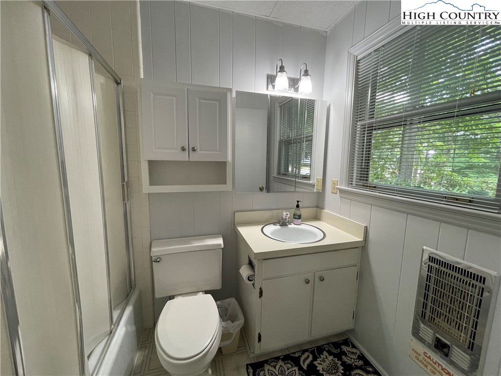 911 Pine Ridge Road Beech Mountain, NC 28604 - Photo 10 of 22 a bathroom with a toilet sink and mirror