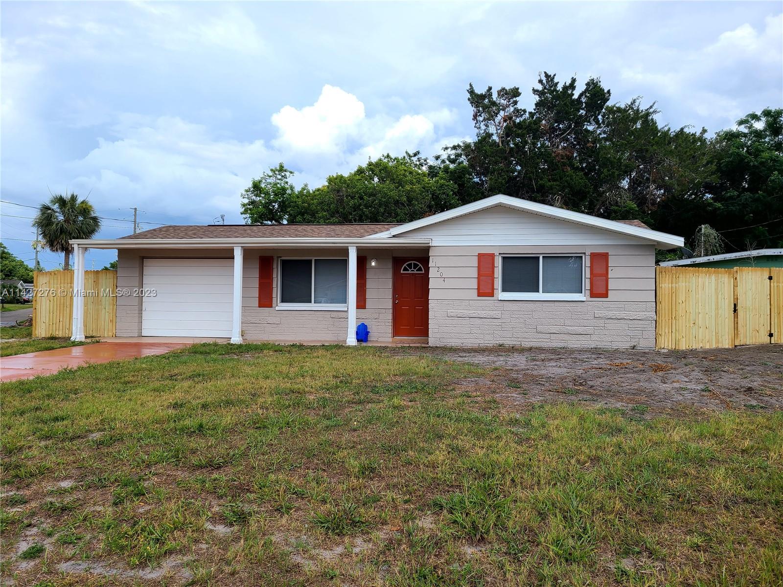 11204 Harding Drive Port Richey, FL 34668 - Photo 1 of 6 a front view of a house with garden