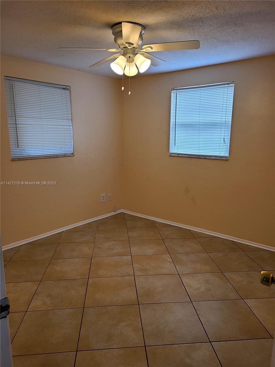 11204 Harding Drive Port Richey, FL 34668 - Photo 3 of 6 a view of an empty room with a chandelier fan