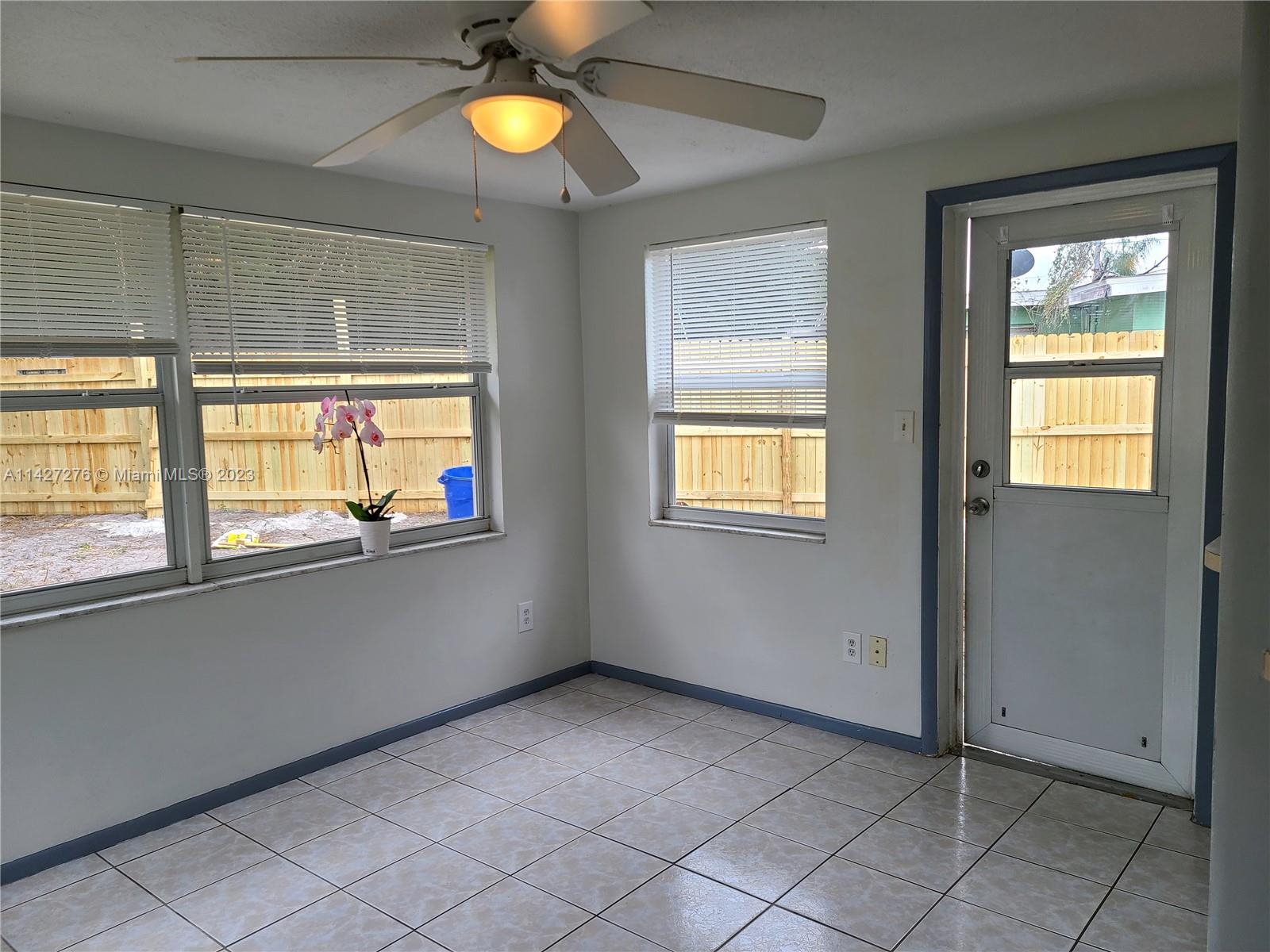 11204 Harding Drive Port Richey, FL 34668 - Photo 6 of 6 a view of an empty room with window and kitchen view