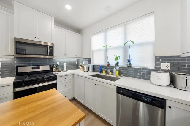 a kitchen with a sink a stove and cabinets