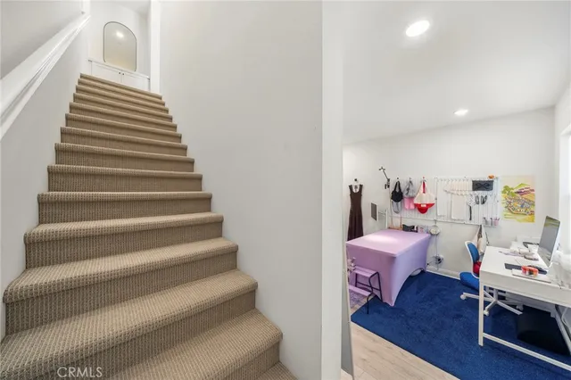 a bedroom with furniture and a wooden floor