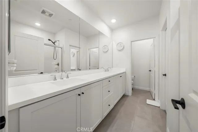 a bathroom with a double vanity sink mirror and double