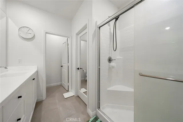 a bathroom with a shower and a sink