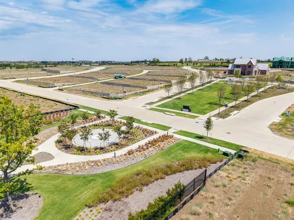 a view of a swimming pool with a lawn chairs under an umbrella