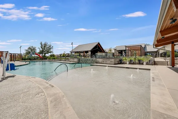 a view of a house with pool and chairs