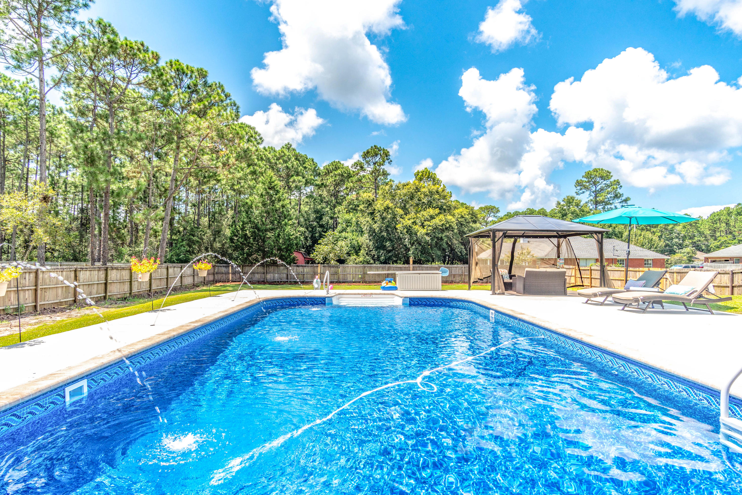 7105 Snug Waters Road Navarre, FL 32566 - Photo 1 of 42 a view of swimming pool with outdoor seating