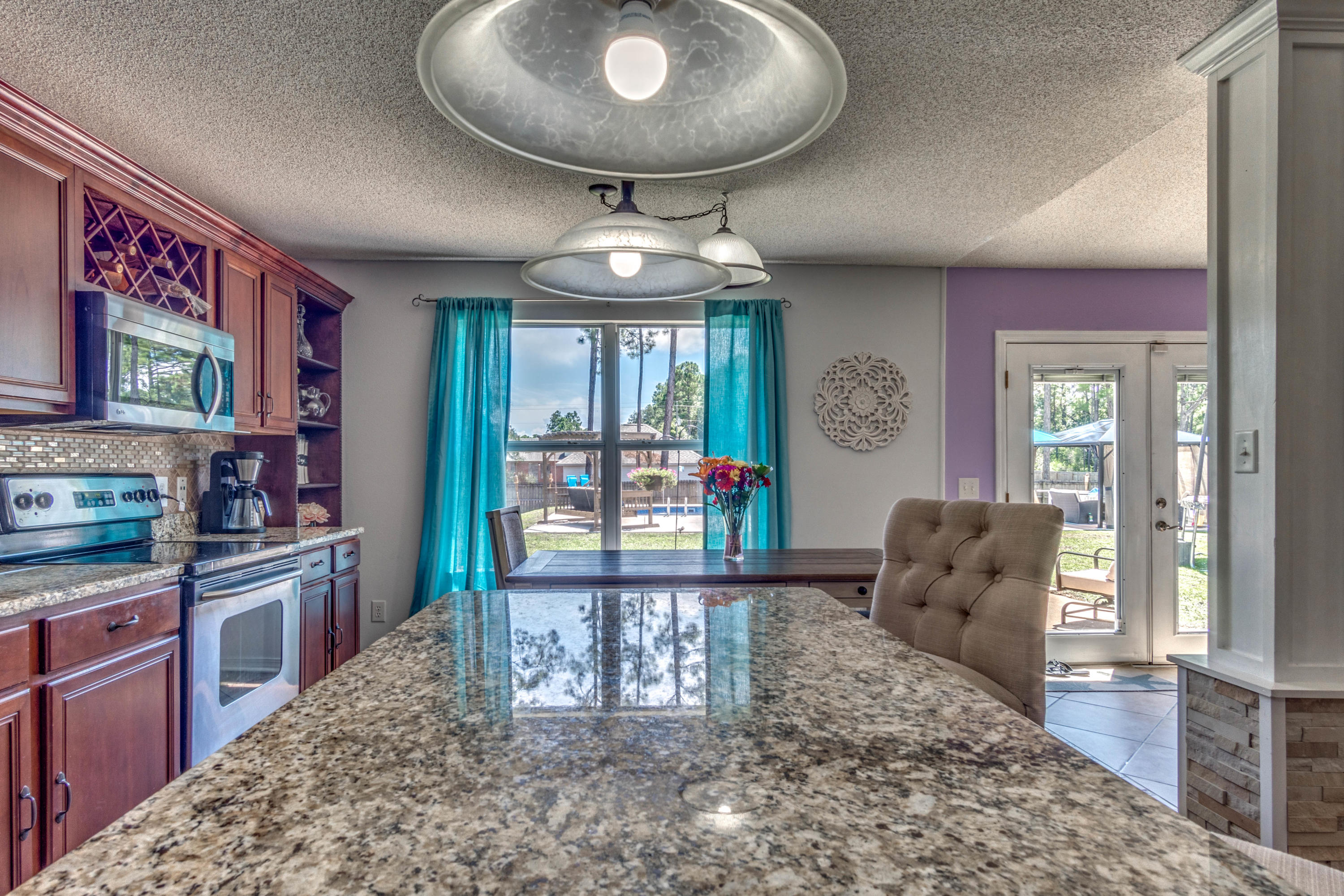 7105 Snug Waters Road Navarre, FL 32566 - Photo 11 of 42 a very nice looking open dining room with wooden floor