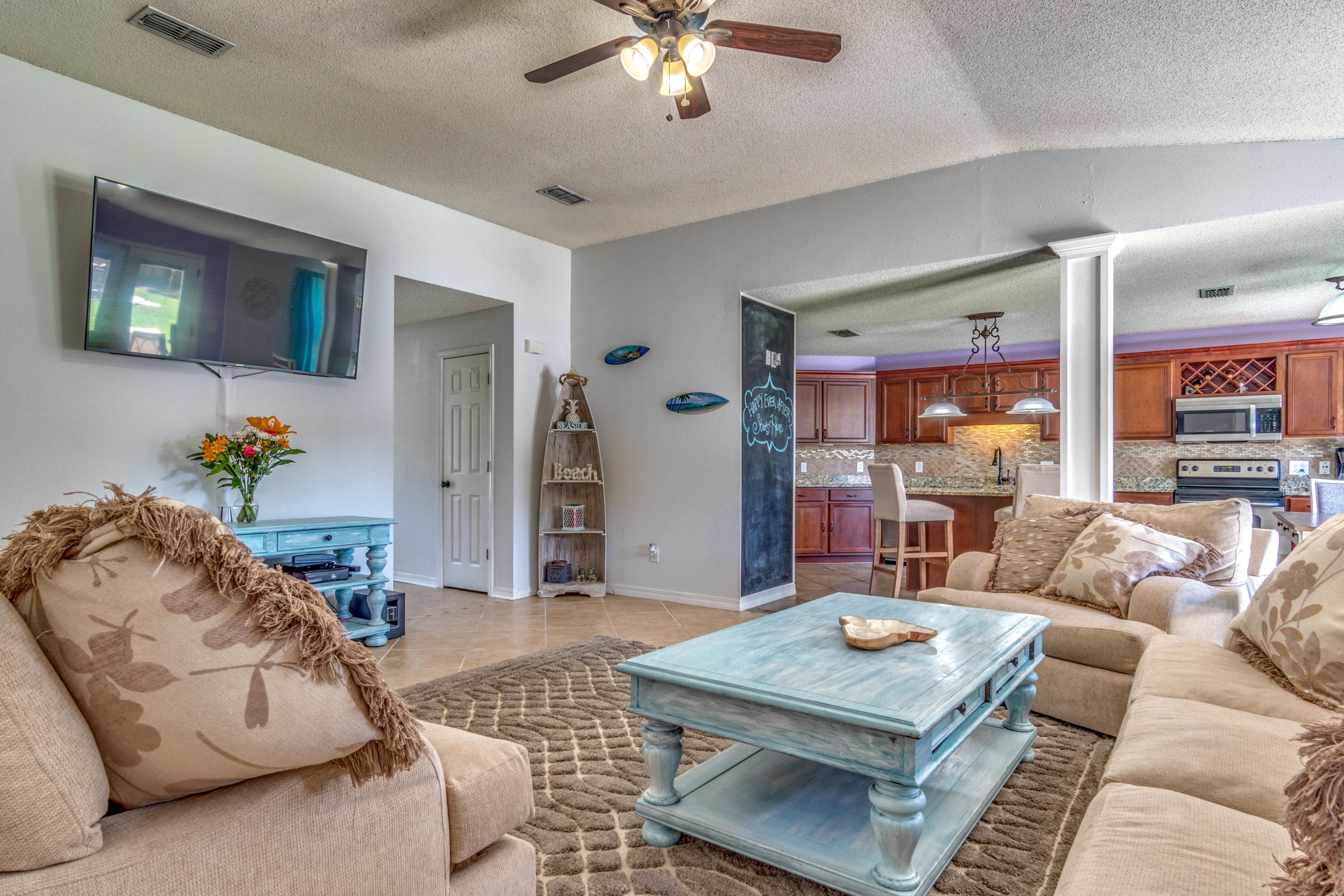 7105 Snug Waters Road Navarre, FL 32566 - Photo 15 of 42 a living room with furniture and a chandelier