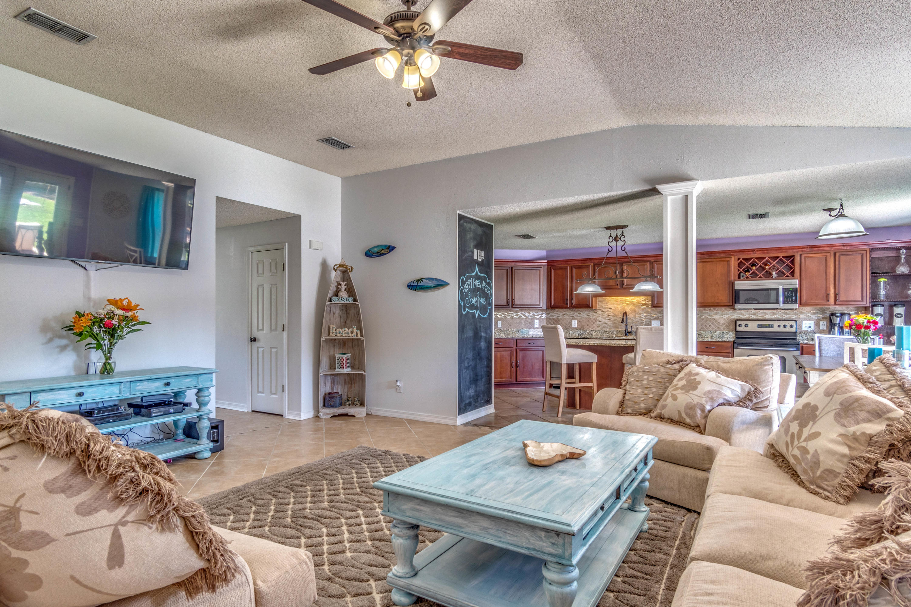 7105 Snug Waters Road Navarre, FL 32566 - Photo 16 of 42 a living room with furniture and wooden floor